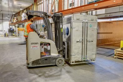 CryoLogistics SnowSHIP Unit being moved by forklift in a refrigerated warehouse